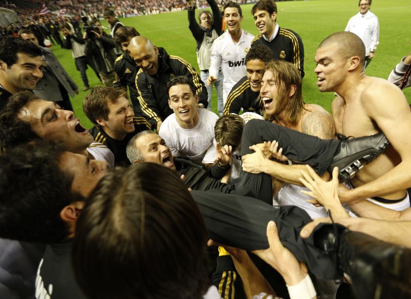 Real Madrid's players toss Mourinho into the sky after clinching the 2012 La Liga title following their victory at Athletic Bilbao. The achievement means he has won league titles in Portugal, England, Italy and Spain.