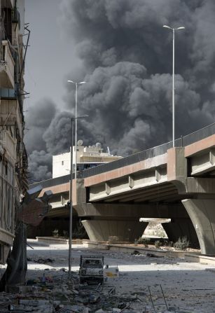 Smoke billows from a burning textile factory after Syrian regime forces shelled a nearby position held by rebels in the Aleppo neighbourhood of Arqub Sunday.