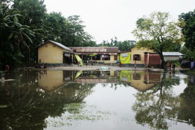 Most of the estimated 300,000 people displaced by the July riots are living in makeshift relief camps in schools. As a result, the start of the academic year has been cancelled for tens of thousands of students.  Here at an emergency relief camp in a school in Kokrajhar district, residents have to wade through a 40-feet wide puddle to access their home. 