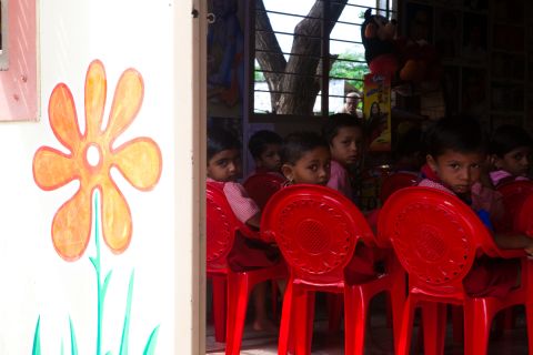 Children eat their morning meals at an anganwadi center, which also provides basic education and health care.