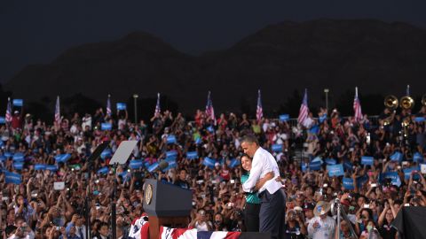 Obama hugs Chasstiry Vazquez after she indroduced him at a campaign event at Desert Pines High School in Las Vegas on Sunday, September 30.