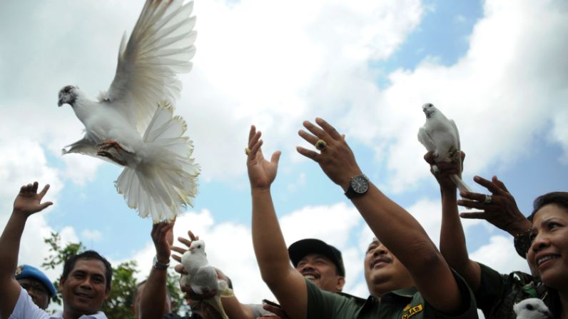 Indonesians release white pigeons in front of the Nyoman Cafe in Jimbaran on Bali on Monday, the seventh anniversary of terrorist bomb blasts that killed at least 24 people. 