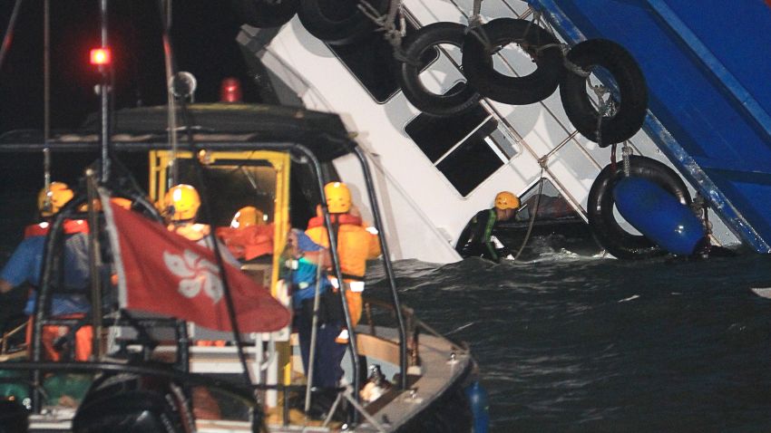 A rescuer looks through a door of a rapidly sinking ship after a collision between a ferry and another boat killed eight people and injured 45 others off Hong Kong late on October 1, 2012. "Up to midnight 53 persons were received by four hospitals and eight were certified dead, " a Hospital Authority spokesman told AFP. The government said around 120 people were on board the vessels, of whom 101 had been rescued. HONG KONG OUT - TAIWAN OUT RESTRICTED TO EDITORIAL USE - MANDATORY CREDIT "AFP PHOTO/Apple Daily" - NO MARKETING NO ADVERTISING CAMPAIGNS - DISTRIBUTED AS A SERVICE TO CLIENTS - NO ARCHIVES AFP PHOTO/Apple DailyAPPLE DAILY/AFP/GettyImages