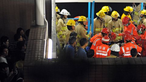 Local residents try to get a glimpse of rescue personnel as they tend to a victim Monday night. The incident happened around 8:20 p.m. local time, just off the coast of Lamma Island, southwest of Hong Kong.