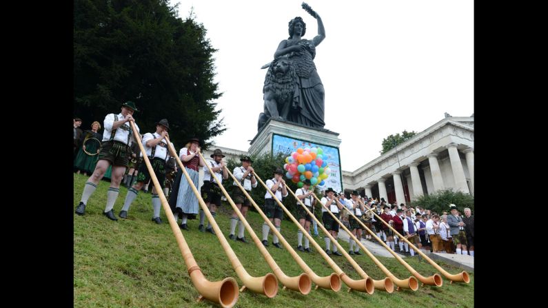 Alphorn musicians play at the foot of the Bavaria monument Sunday.