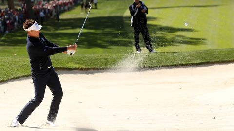 Ian Poulter of Europe plays a bunker shot Sunday on the fourth hole.