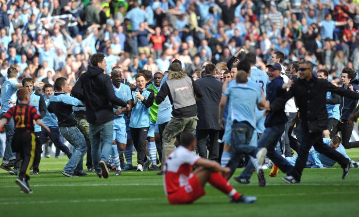 Players and fans of Manchester City celebrate after winning their first English title since 1968. City trailed Queens Park Rangers 2-1 but scored two stoppage time goals to win 3-2 - and so deny city rivals Manchester United the title. The success echoed United's 1999 Champions League triumph in Barcelona, where they beat Bayern Munich 2-1 despite trailing after 90 minutes. 