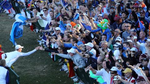 Nicolas Colsaerts, left, celebrates with fans after Europe beat the United States on Sunday. The biennial competition pits the best pro golfers from the United States against their European counterparts.
