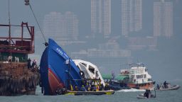 The bow of the Lamma IV boat (L) is seen partially submerged during rescue operations on October 2, 2012 the morning after it collided with a Hong Kong ferry killing over 30 people. The boat, filled with more than 120 people headed to watch a national day fireworks display in Victoria harbour, collided with a passenger ferry and sank off Hong Kong, leaving 36 people dead and sparking a frantic overnight search and rescue effort, officials said on October 2