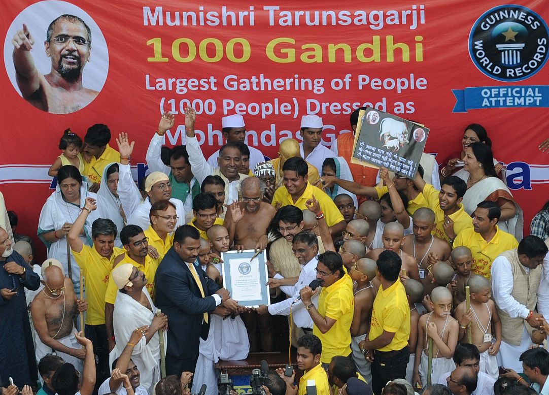 Jain Muni Shri Tarun Sagarji, center, accepts a certificate from an official of Guinness World Records.