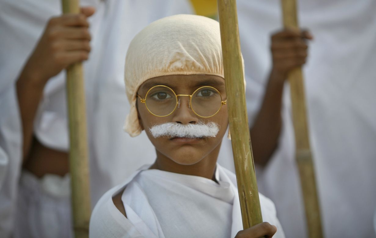  A schoolboy dressed as Gandhi takes part in a march on Tuesday.