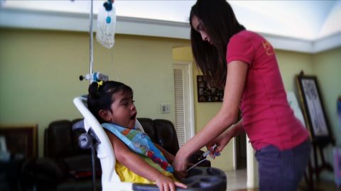 Alexa Wilson cares for her younger sister, Brianna, who has gastroparesis, or paralysis of the stomach muscles.