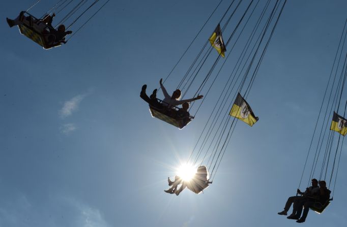 Festivalgoers enjoy a ride at the Theresienwiese fairgrounds in Munich, Germany, at the Oktoberfest beer festival on Tuesday, October 2.