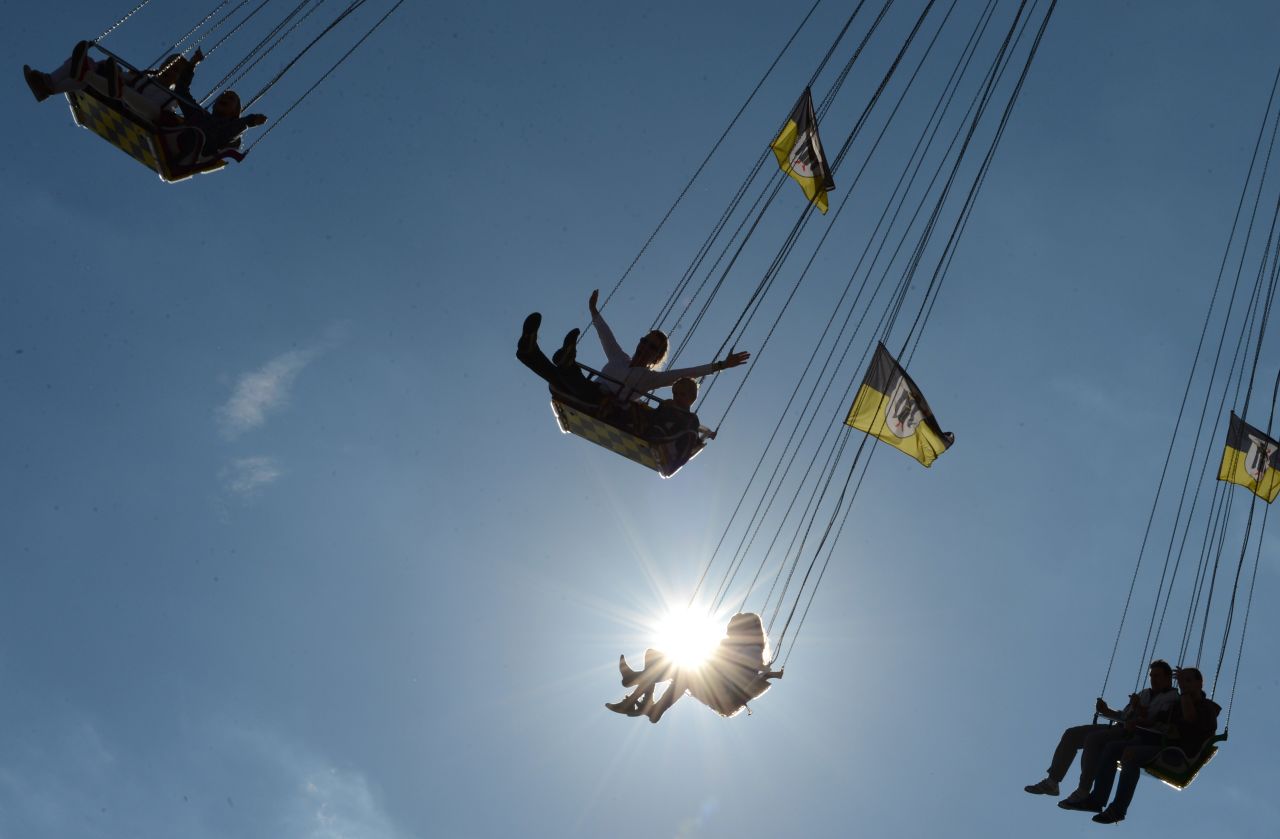 Festivalgoers enjoy a ride at the Theresienwiese fairgrounds in Munich, Germany, at the Oktoberfest beer festival on Tuesday, October 2. 