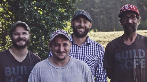 Brian Preston, in plaid, and Lamon Luther employees Jeffery Hanson, Scott Miller and Roger Anthony Curtis.