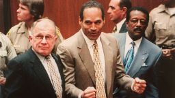 O.J. Simpson, flanked by lawyers F. Lee Bailey and Johnnie Cochran, celebrates on October 3, 1995, as a Los Angeles jury acquits him of murder in the deaths of ex-wife Nicole Brown Simpson and her friend Ron Goldman.