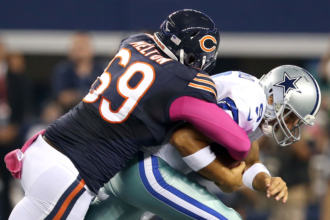 Henry Melton of the Bears sacks quarterback Tony Romo of the Cowboys in the first quarter on Monday.