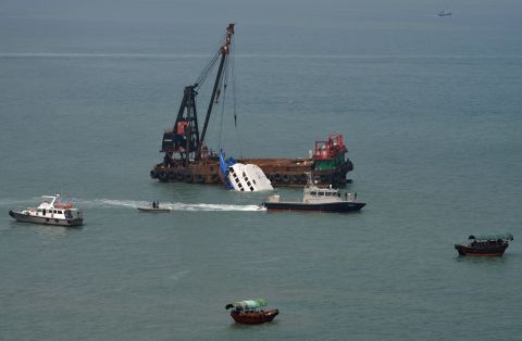 The boat that collided with a Hong Kong passenger ferry is partially submerged during rescue operations Tuesday, October 2. 
