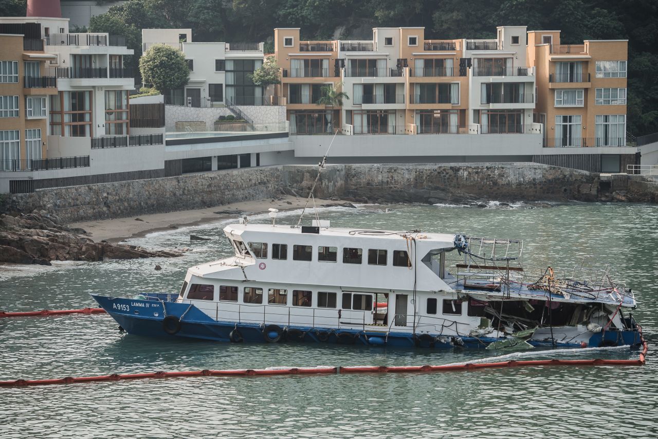 The passenger boat, with the back end of the vessel badly damaged after the collision, sits near the shores of Lamma Island on Wednesday. 