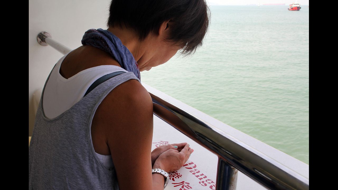 A woman offers a prayer on board a ferry off Hong Kong on Wednesday.