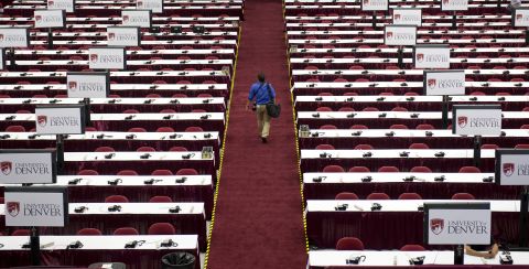 A man walks through the media center as preparations continue on Monday.