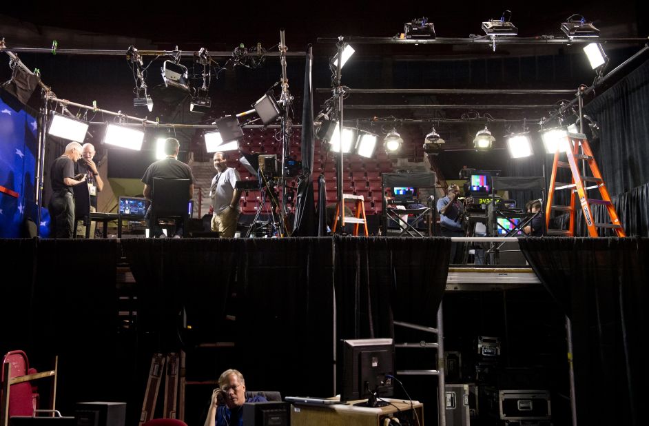 Workers prepare the set for the television anchors during the first presidential debate at the University of Denver on Monday, October 1. 