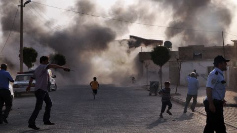 Smoke rises from an explosion after Syrian shells hit the town of Akcakale in Turkey, killing at least five people.