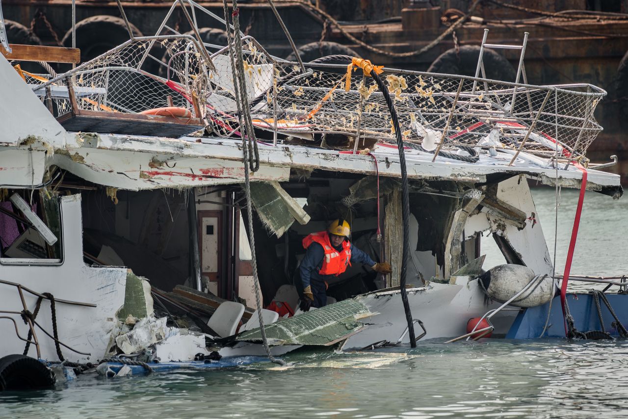 A fireman inspects the back end of the badly damaged Lamma IV passenger boat two days after the collision.