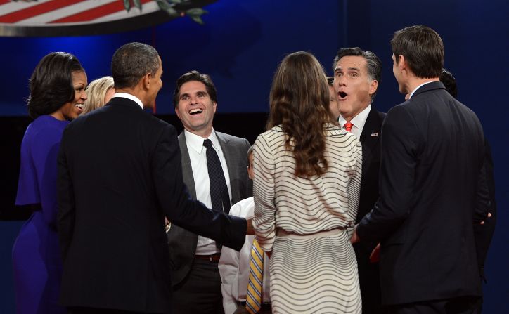 Michelle and Barack Obama, left, join Mitt Romney and his family at the conclusion of the first presidential debate.