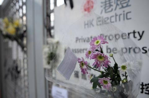 Bouquets of flowers and black ribbons hang on the gate to the HK Electric private pier on Thursday.