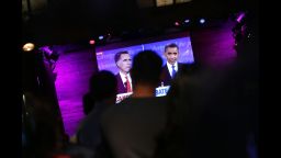 People watch at Galapagos Art Space in Brooklyn as U.S. President Barack Obama and Republican presidential candidate, former Massachusetts Gov. Mitt Romney participate in their highly anticipated first debate Wednesday night at the University of Denver on October 3, 2012 in New York City. The debate is broken into three segments: the economy,health care and the role of government. Romney, who is trailing in most major polls, is looking to deliver a strong performance in order to gain leverage over the president going into the final weeks of the campaign.
