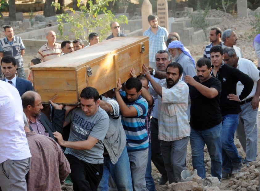 A victim's coffin is carried through town Thursday. Turkey hammered Syrian targets in reprisal for the cross-border fire that sent tensions soaring in the region, prompting international calls for restraint.