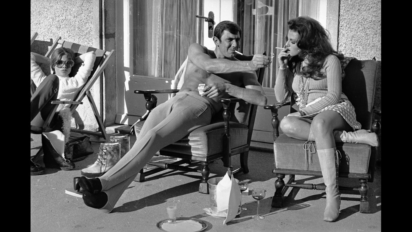 George Lazenby offers co-star Helena Ronee a light during the filming of "'On Her Majesty's Secret Service" in the Swiss Alps in October 1968.