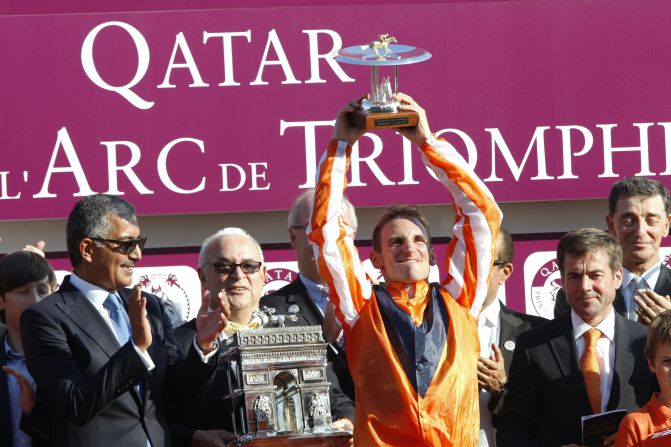 Jockey Andrasch Starke celebrates on the podium after German horse Danedream wins the 2011 race. The defending champion was banned from traveling this year after training at the Cologne racecourse, which is under strict quarantine following the detection of swamp fever. 