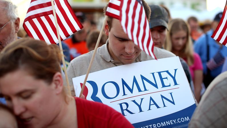 Romney supporters bow their heads in prayer during Thursday's event at the Augusta Expoland in Fishersville, Viriginia.