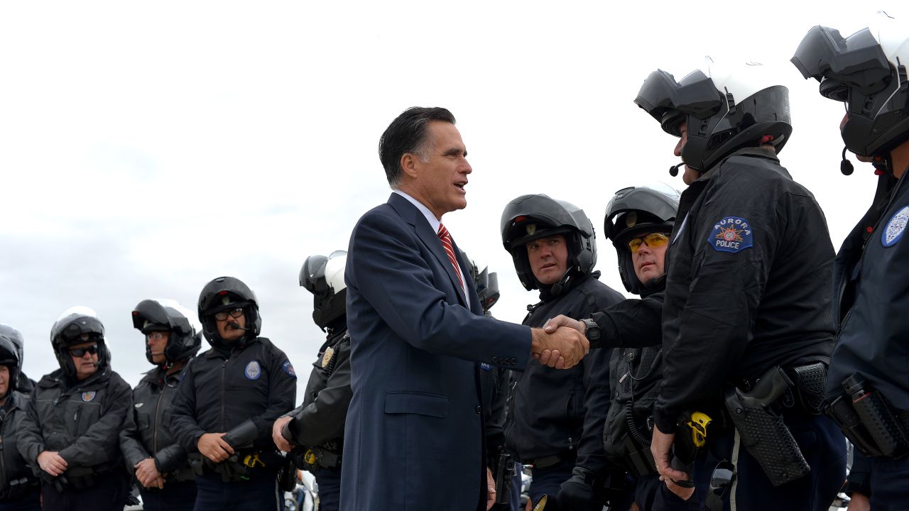Romney greets police officers before boarding his campaign plane in Denver on Thursday.