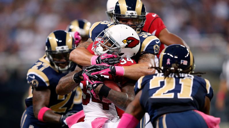 Ryan Williams of the Arizona Cardinals carries the ball with No. 55 James Laurinaitis of the St. Louis Rams on his back.