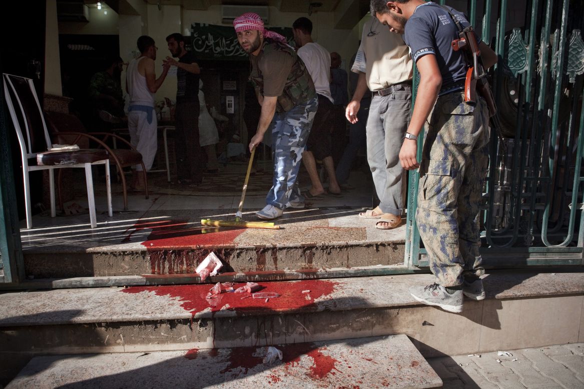 A Dar El Shifa worker cleans the floor outside the hospital in Aleppo on Thursday.