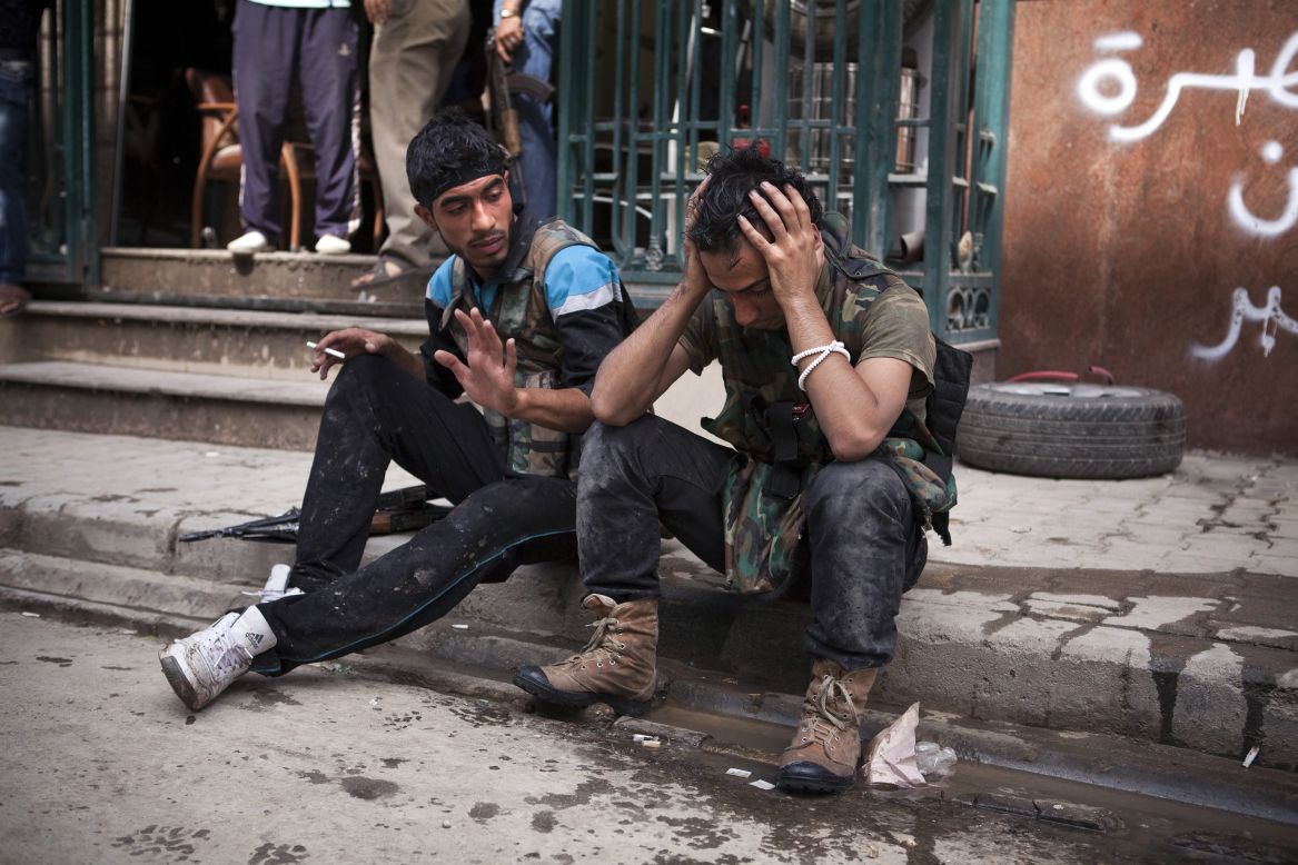 A Free Syrian Army fighter cries after one of his friends was injured in fighting with government forces outside the Dar El Shifa hospital on Thursday.