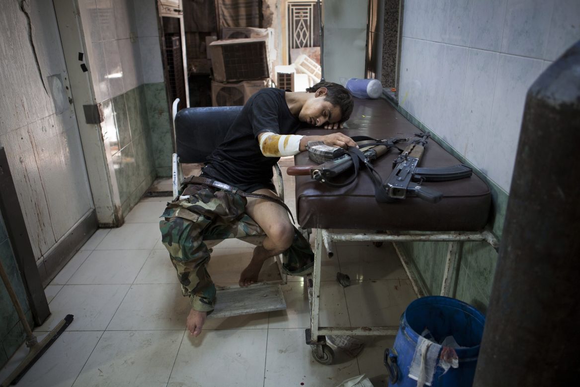 An injured Free Syrian Army fighter rests after receiving treatment at Dar al Shifa hospital in Aleppo on Thursday, October 4.