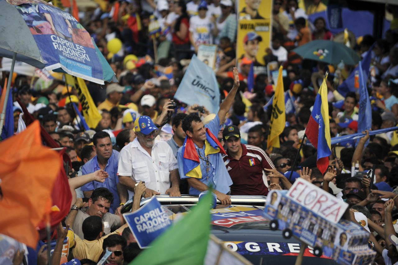 Venezuelan opposition presidential candidate Henrique Capriles Radonski, center, waves to supporters during a campaign rally on Thursday in San Fernando de Apure.
