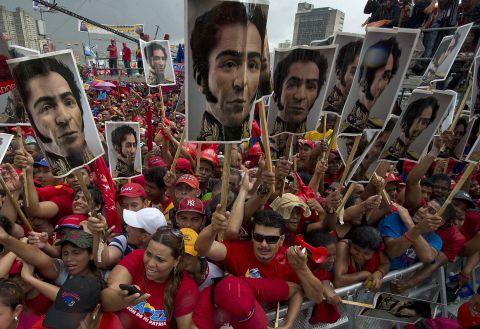 Chavez supporters hold photos of Simon Bolivar, who led Venezuela's fight for independence from Spain in the 1820s, during Chavez's campaign wrap-up rally in Caracas on Thursday, October 4.