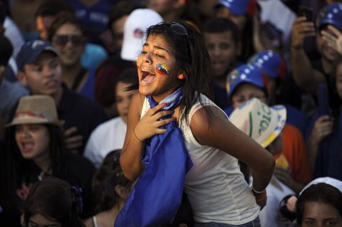 A supporter of the opposition candidate, Capriles, screams during a campaign rally in Maracaibo.