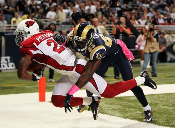 Patrick Peterson of the Arizona Cardinals intercepts a pass intended for Brian Quick of the St. Louis Rams during the game in St. Louis on Thursday, October 4.