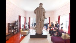 The art installation "Discovering Columbus" takes the form of a modern New York living room surrounding the 13-foot marble statue of Christopher Columbus. 
