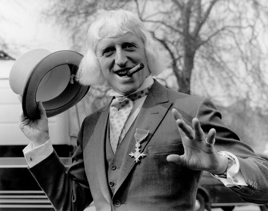 Jimmy Savile sports his Order of the British Empire medal after his 1972 investiture at Buckingham Palace in London.