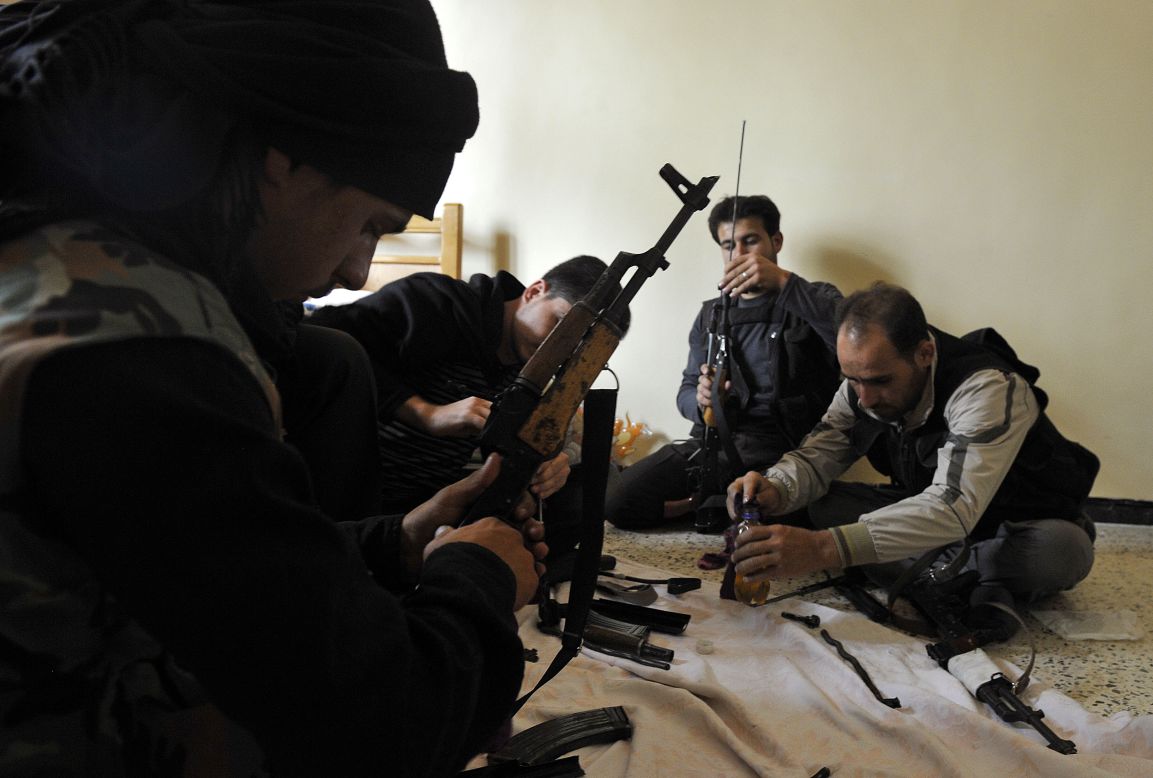 Syrian members of the Al-Saiqa rebel brigade clean weapons on Saturday before going to the front line in Aleppo.