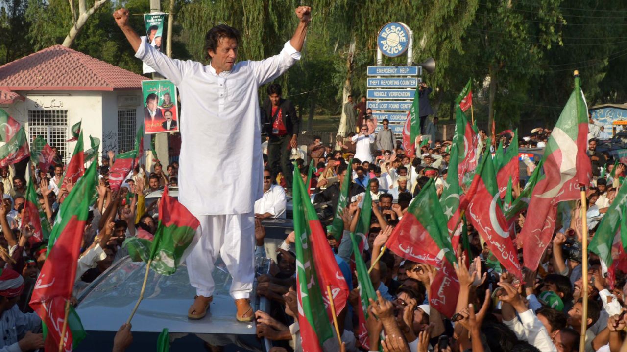 Pakistan cricket star turned politician Imran Khan gestures as he stands on a vehicle during a rally in Mianwali, northern Pakistan, on October 6, 2012. 