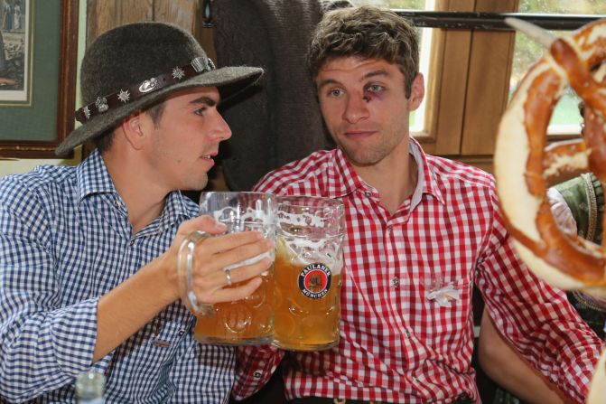 Philipp Lahm, left, of the German football team Bayern Munchen attends the Oktoberfest beer festival with his teammate Thomas Mueller in Munich, Germany, on Sunday, October 7, the last day of the world's biggest beer festival. <a >See more of CNN's best photography.</a>