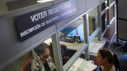 Dorothy Torrence, from the Miami-Dade Elections Department, helps Viviana Camacho with information about her voter registration in Miami, Florida.